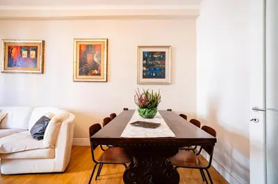 a dining room with a table and a couch at Vatican Blossom in Rome