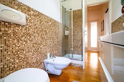 a bathroom with a toilet and a shower and a sink at Vatican Blossom in Rome