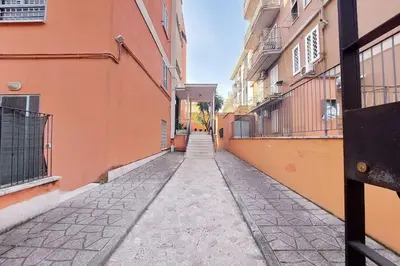 an empty alley between two buildings in a city at Lucky Domus Tuscolano in Rome