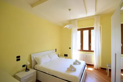 a bedroom with a white bed and a window at HC - CloHouse Spacious Flat in Rome