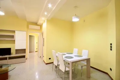 a dining room with a table and white chairs at HC - CloHouse Spacious Flat in Rome