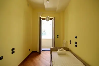 a room with a bed in a room with yellow walls at HC - CloHouse Spacious Flat in Rome