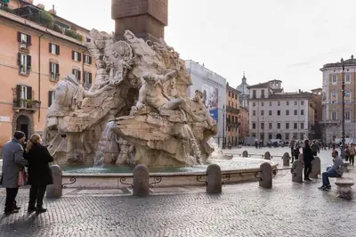 a fountain in a city with people standing around it at Casa degli Spagoli Navona Square in Rome
