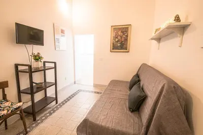 a living room with a couch and a television at Casa degli Spagoli Navona Square in Rome