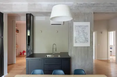 a kitchen with a sink and blue chairs at Modern Spacious Apartment on the Tevere in Rome