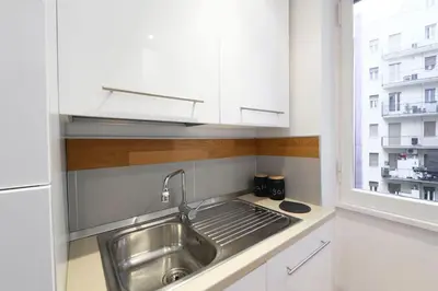 a kitchen with a stainless steel sink and a window at St Peter s Home, nel cuore della Città Eterna in Rome