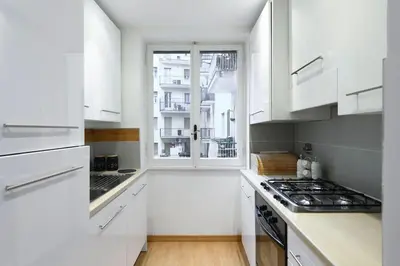 a white kitchen with a stove and a window at St Peter s Home, nel cuore della Città Eterna in Rome