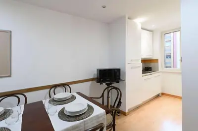 a kitchen and dining room with a table and chairs at St Peter s Home, nel cuore della Città Eterna in Rome