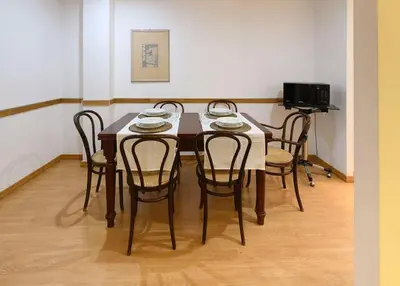 a dining room table with four chairs and a television at St Peter s Home, nel cuore della Città Eterna in Rome