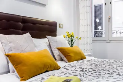 a bedroom with a bed with yellow pillows at Sant'Angelo Apartments in Rome