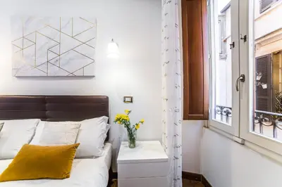 a bedroom with a bed and a window at Sant'Angelo Apartments in Rome
