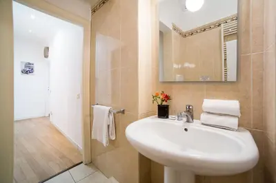 a bathroom with a sink and a mirror at Sant'Angelo Apartments in Rome