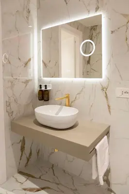 a white bathroom with a sink and a mirror at 56 Orange Street Luxury Accommodation in Rome