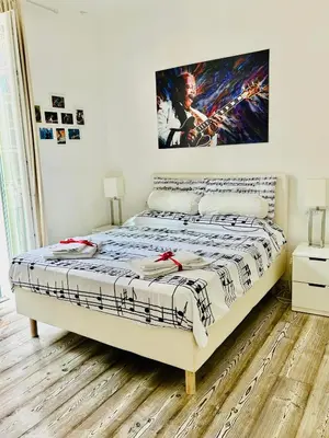 a bedroom with a bed with a poster on the wall at Big Johnny B in Rome