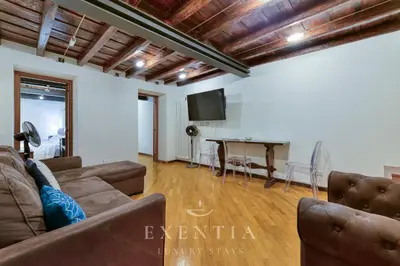 a living room with a couch and a table at Exentia Stays - Luxury Apartment Colosseum in Rome