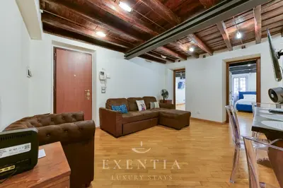 an image of a dining room with a table and chairs at Exentia Stays - Luxury Apartment Colosseum in Rome
