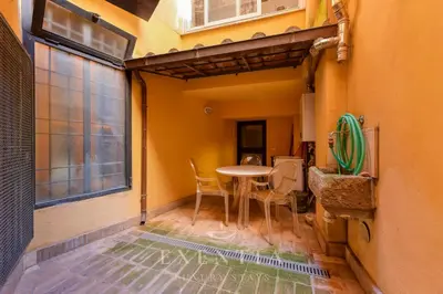 a small room with a table and a window at Exentia Stays - Luxury Apartment Colosseum in Rome