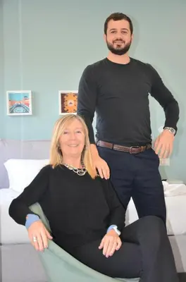 a man standing next to a woman sitting on a couch at Vatican View Experience in Rome