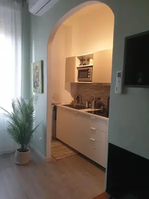 a kitchen with a sink and a kitchen with an archway at Appartamento La Doriana in Rome