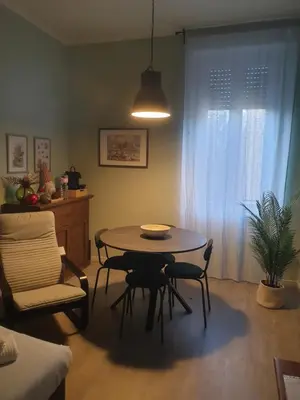 a dining room with a table and chairs in a room at Appartamento La Doriana in Rome