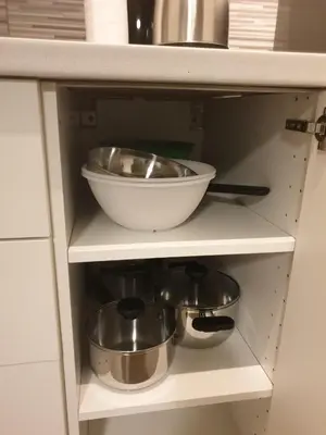 a shelf with a bowl and pans in a kitchen at Appartamento La Doriana in Rome