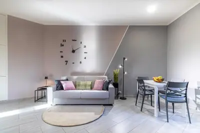 a living room with a couch and a table with a clock at Casa Gabea in Rome