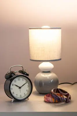 a lamp and an alarm clock sitting next to a alarm clock gmaxwell gmaxwell gmaxwell at Casa Gabea in Rome