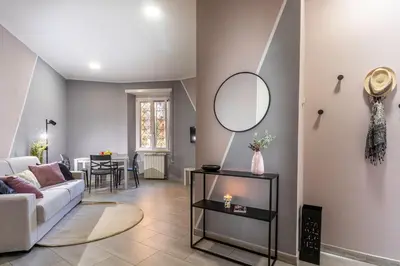 a living room with a couch and a mirror at Casa Gabea in Rome