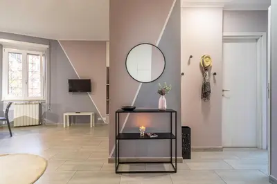 a living room with a mirror and a table at Casa Gabea in Rome