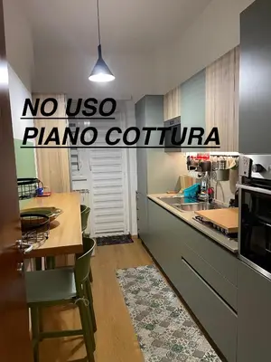 a kitchen with a no uso plano cortina sign at Cornelia Battistini - Ampia camera con bagno privato in Rome