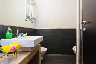 a bathroom with a white sink and a toilet at Domus Best Guest House in Rome