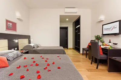 a bedroom with a bed with red hearts on it at Domus Best Guest House in Rome