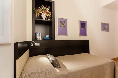 a bedroom with a bed with a head board at Domus Best Guest House in Rome