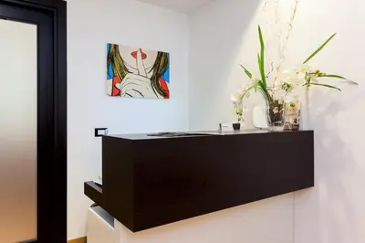 a black dresser with a painting on the wall at Domus Best Guest House in Rome