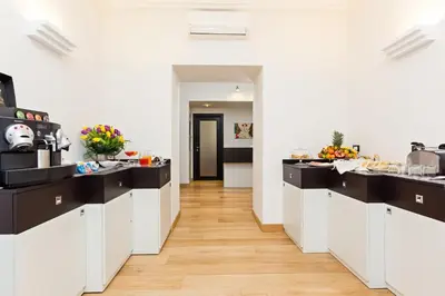 a kitchen with black and white counter tops at Domus Best Guest House in Rome