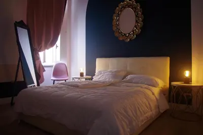 a bedroom with a bed with a mirror and a chair at Enotri Guest House - Rome in Rome