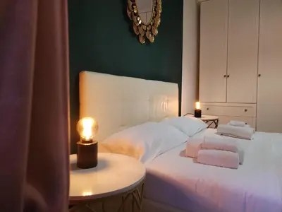 a bedroom with a white bed with a lamp on a table at Enotri Guest House - Rome in Rome