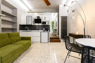 a bedroom with a large white bed with yellow pillows at New Modern in Trastevere with Garden in Rome