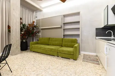a bedroom with a large white bed with yellow pillows at New Modern in Trastevere with Garden in Rome
