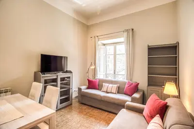 a living room with a couch and a table at Suite Experience San Giovanni Apartments in Rome