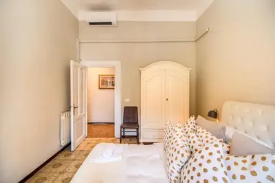 a bedroom with a bed and a chair at Suite Experience San Giovanni Apartments in Rome
