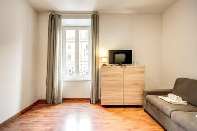 a living room with a couch and a television at Suite Experience San Giovanni Apartments in Rome
