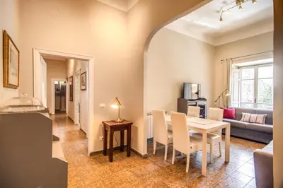 a dining room and living room with a table and chairs at Suite Experience San Giovanni Apartments in Rome