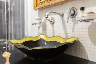 a black and yellow sink in a bathroom at Elegant apartment in Trastevere in Rome