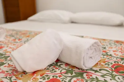 a towel sitting on top of a bed at Elegant apartment in Trastevere in Rome