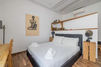 a bedroom with a bed with white towels on it at Cesare Balbo - B&D Apts in Rome