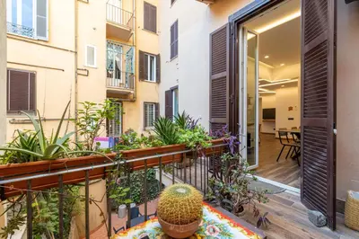 an open balcony with plants on a building at Cesare Balbo - B&D Apts in Rome