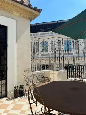 a table and chairs on a balcony with a building at Elegante appartamento con terrazzo in Rome