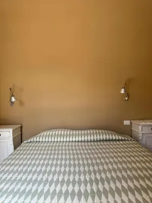 a bedroom with a bed with two dressers and two lights at Elegante appartamento con terrazzo in Rome