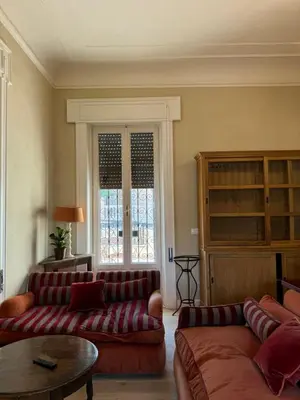 a living room with two couches and a table at Elegante appartamento con terrazzo in Rome